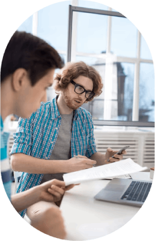 Study session – Two students reviewing documents together.