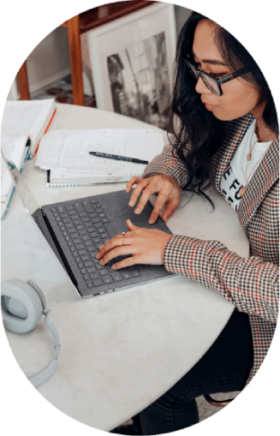 Studying online – Woman typing notes on laptop.