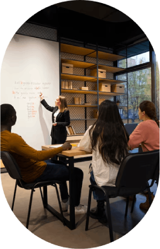 Classroom learning – Teacher explaining lesson to engaged students.